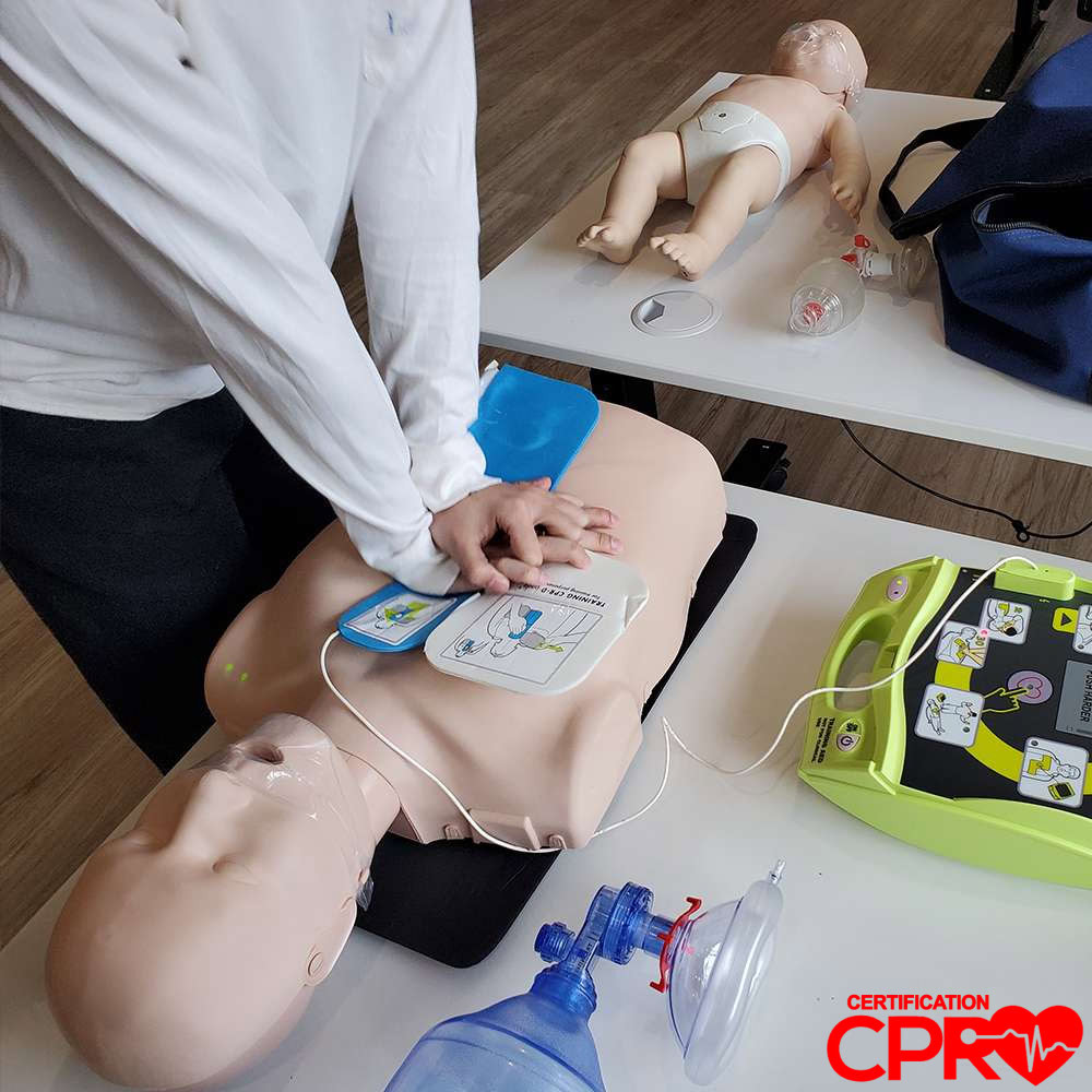 CPR training with mannequin and AED for certification in Chicago.
