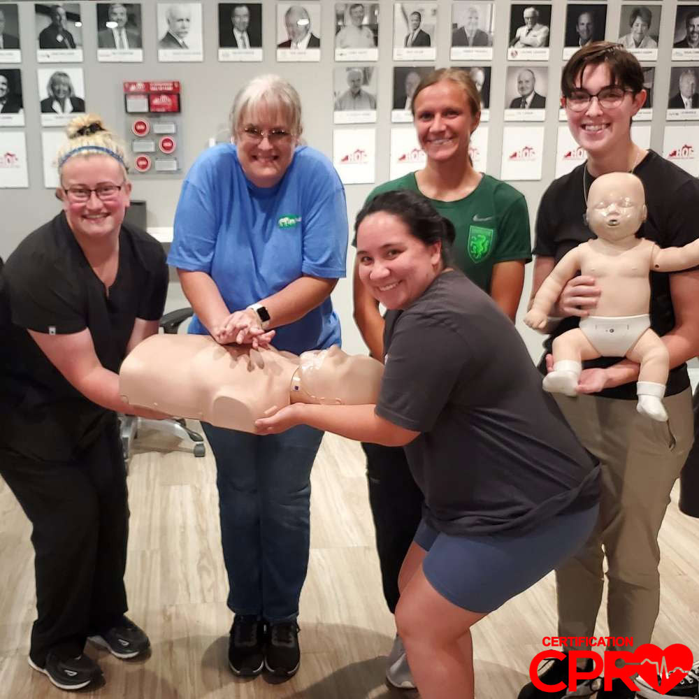 CPR training class in Chicago with students practicing on mannequins.